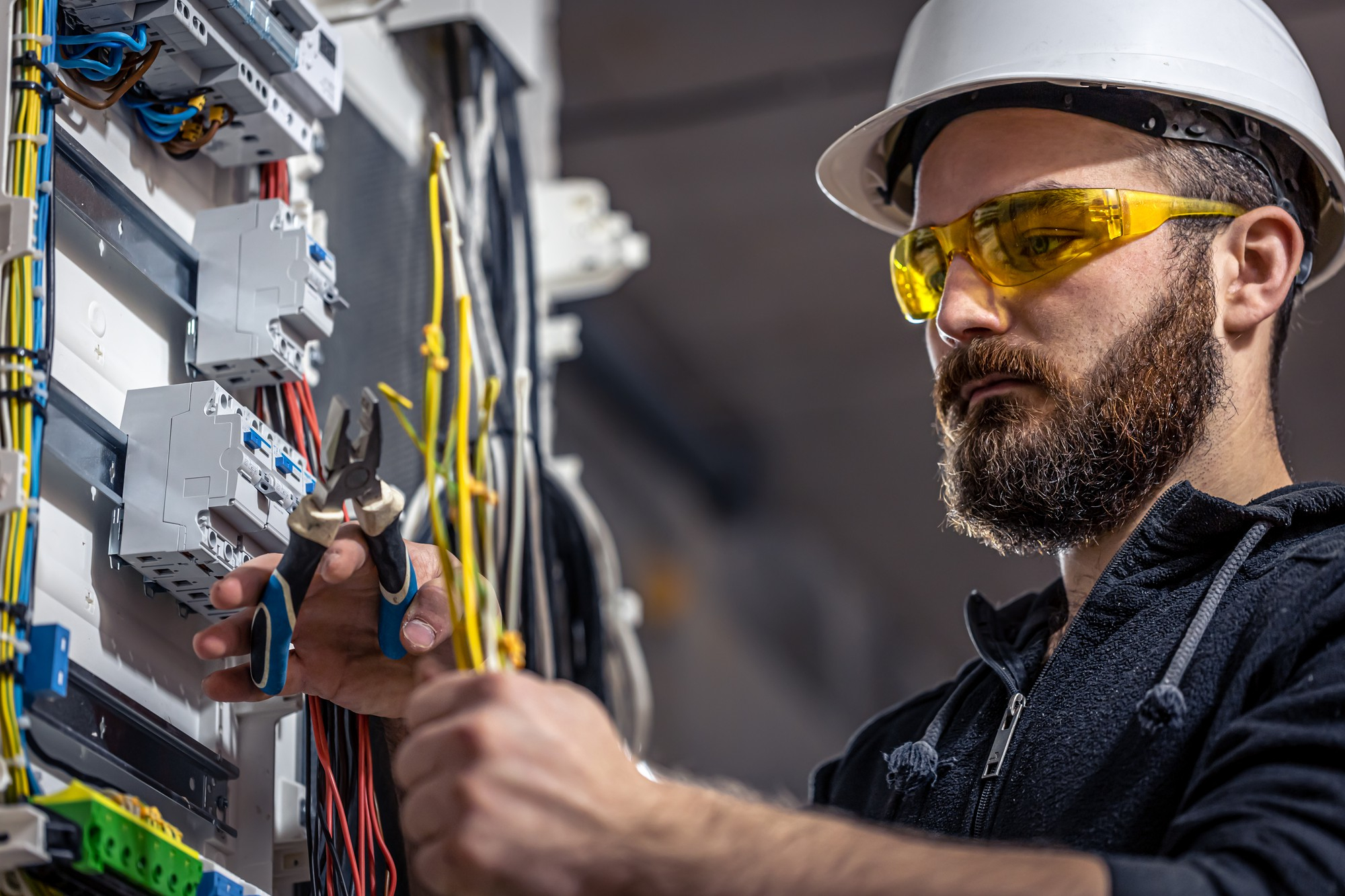 shallow focus photo of man fixing steel cable